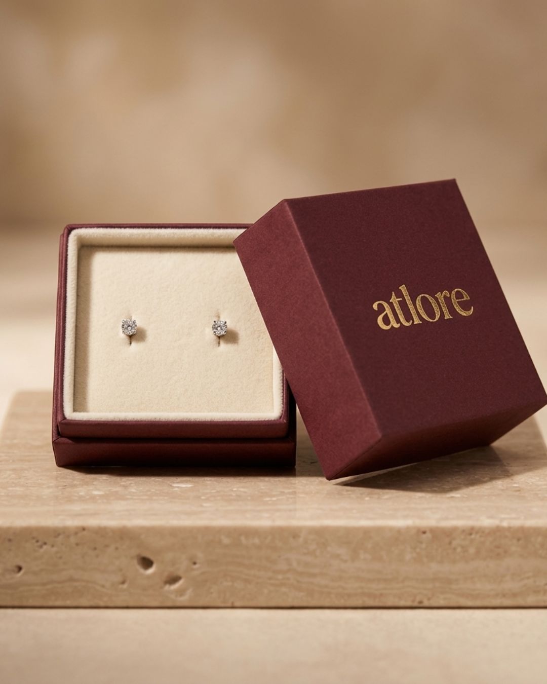 Custom wholesale 2-piece deep maroon paper earring box with a cream velvet inner pad and gold foil Atlore branding.