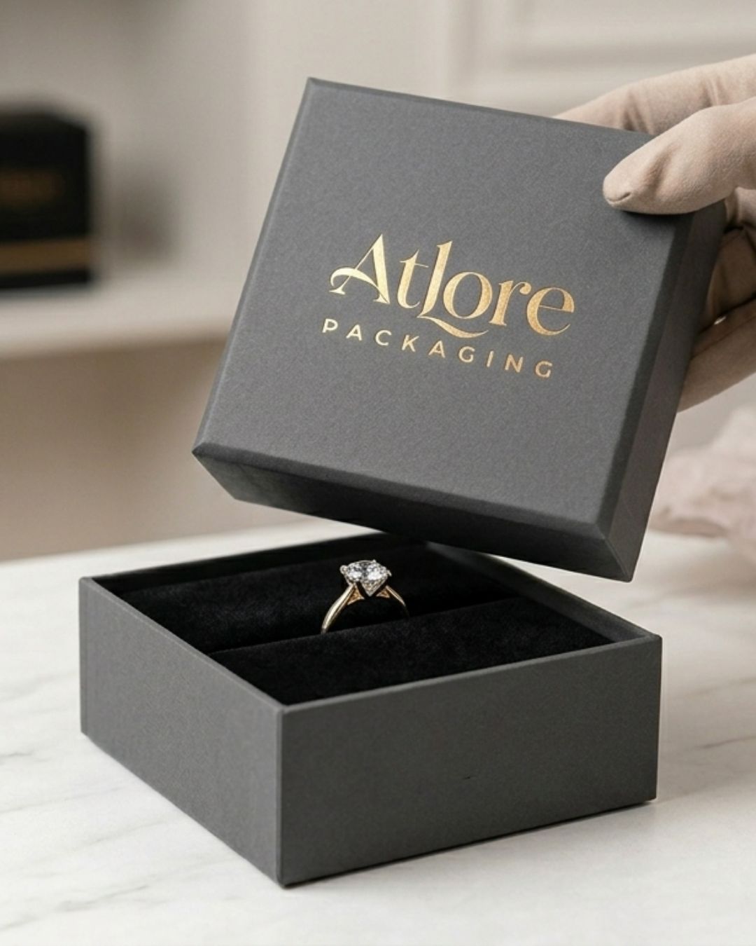 Rigid 2-piece charcoal grey paper ring box featuring a black pigpell material covered inner pad for boutique jewelry packaging by Atlore.