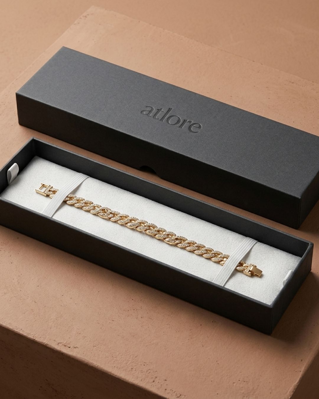 Custom wholesale long charcoal paper 2-piece bracelet box with a white pigpell fabric inner pad and debossed Atlore branding.