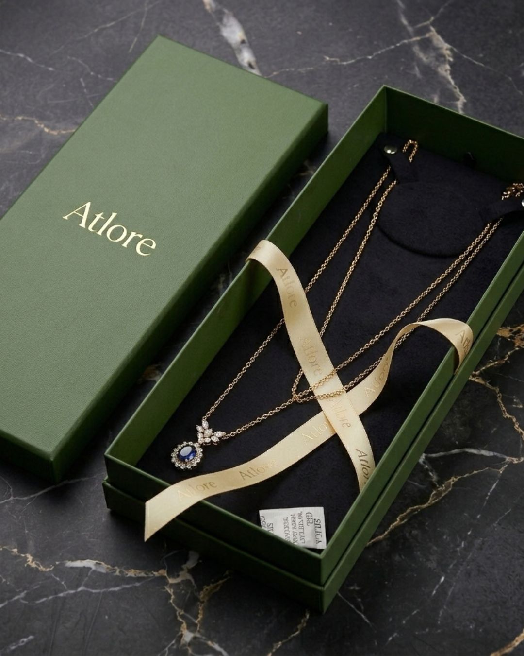 Custom grand-scale matte black paper 2-piece necklace packaging box featuring a contoured cream velvet display pad by Atlore.