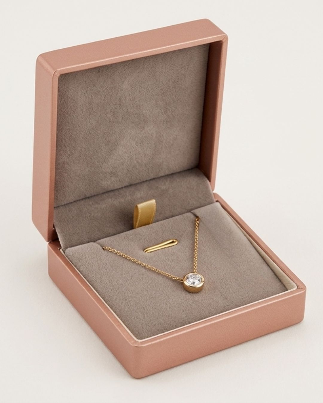 Wholesale brushed rose gold metallic paper-plastic box featuring a soft taupe suede lined inner display pad.