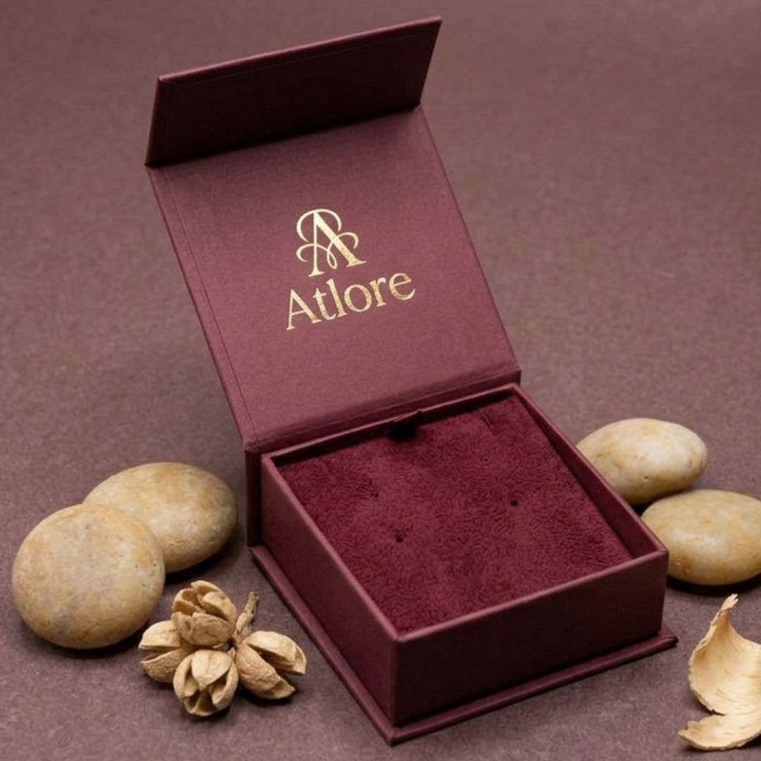 Custom 2-piece flip-top style deep maroon paper magnetic earring box with a matching velvet lining.