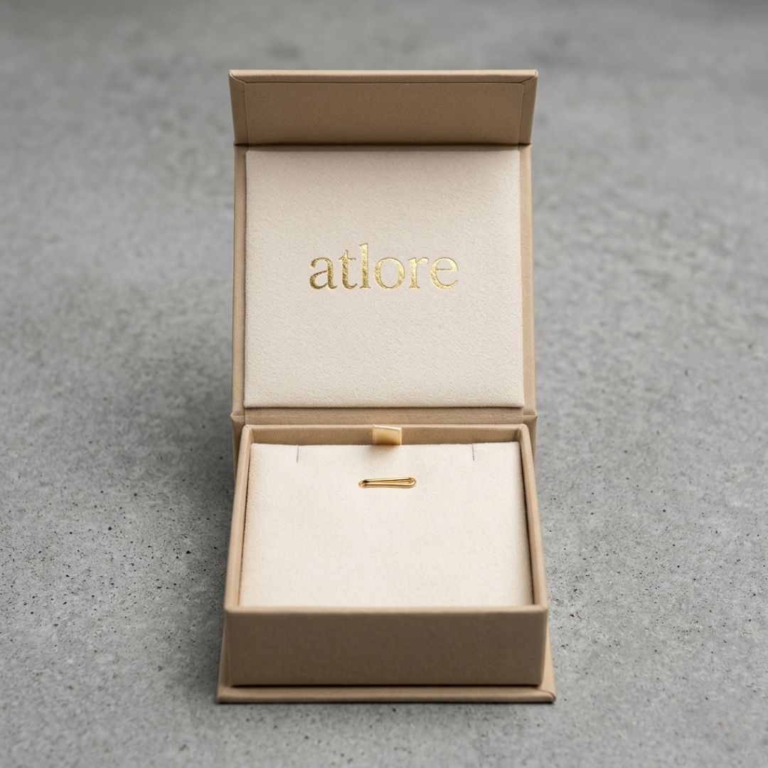 Warm beige paper magnetic pendant box featuring a cream microfiber interior display pad by Atlore.