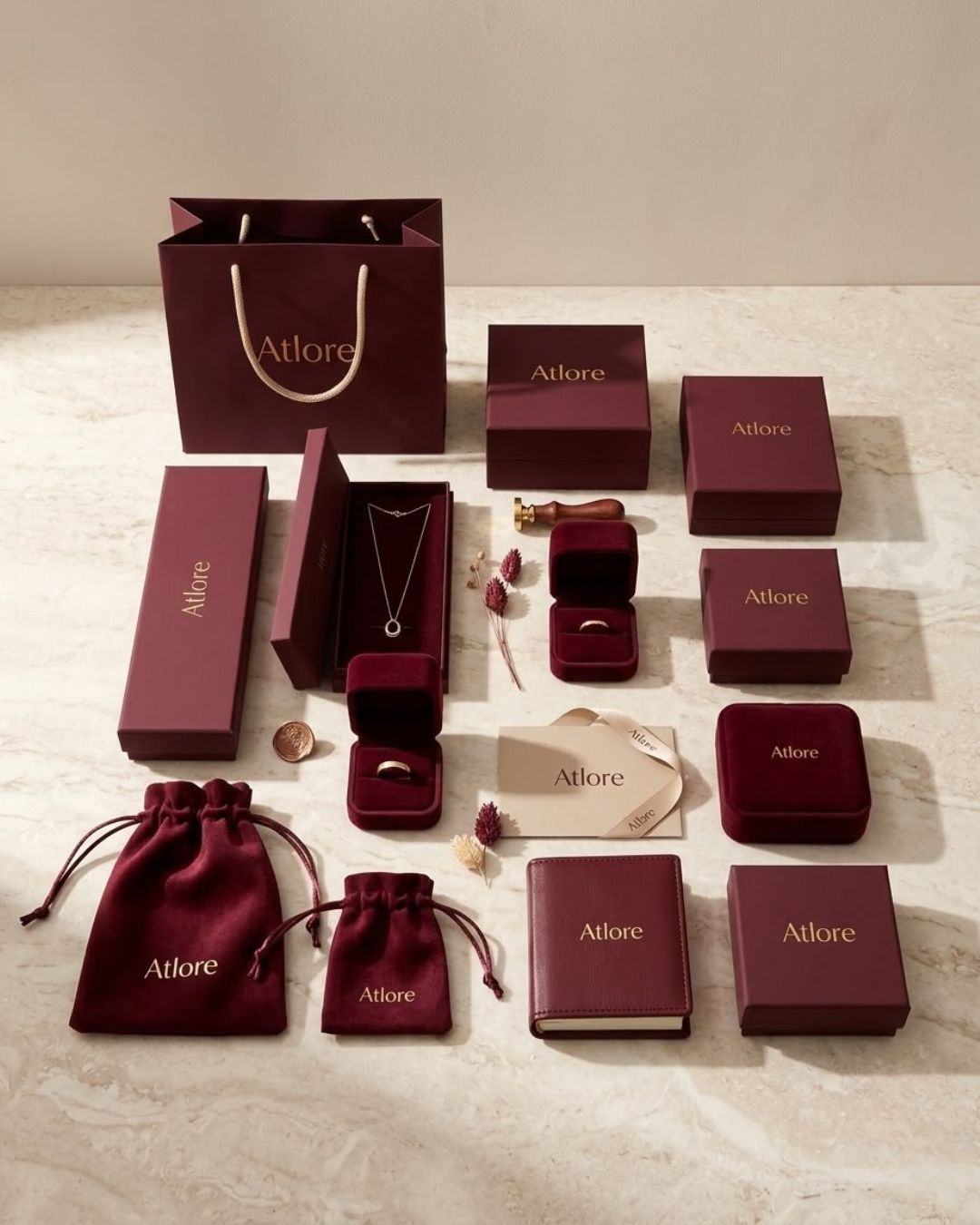 Matching set of luxury jewelry packaging including custom paper bags, rigid gift boxes, and velvet pouches.